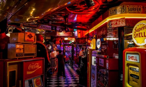people playing arcade games at a bar - bar and games near me