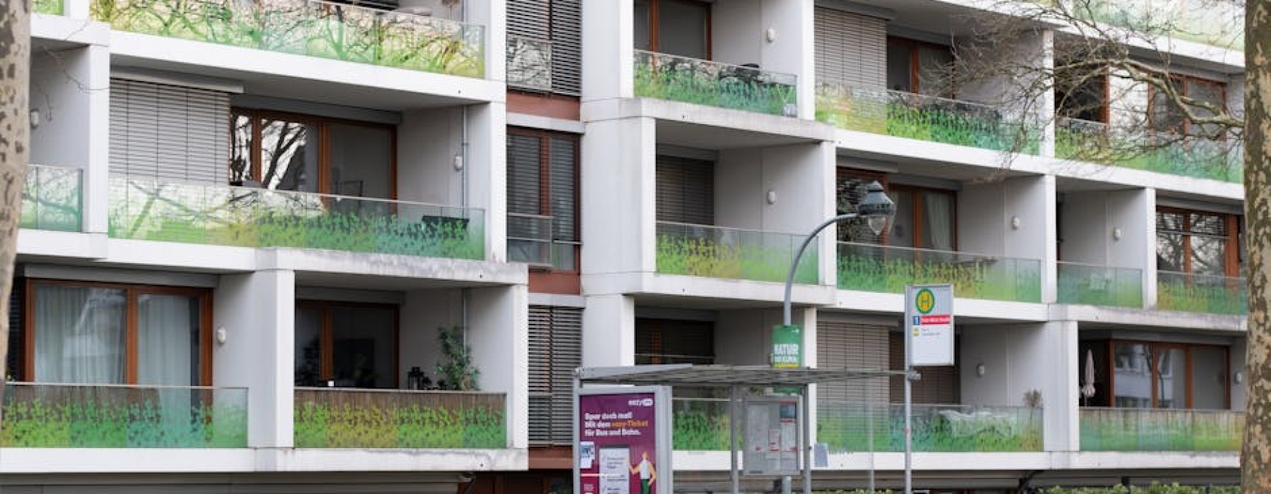 modern apartment building near bus stop - apartments near bus routes