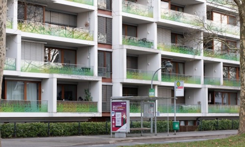 modern apartment building near bus stop - apartments near bus routes